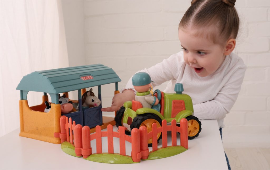 A child playing with the First Friends farm